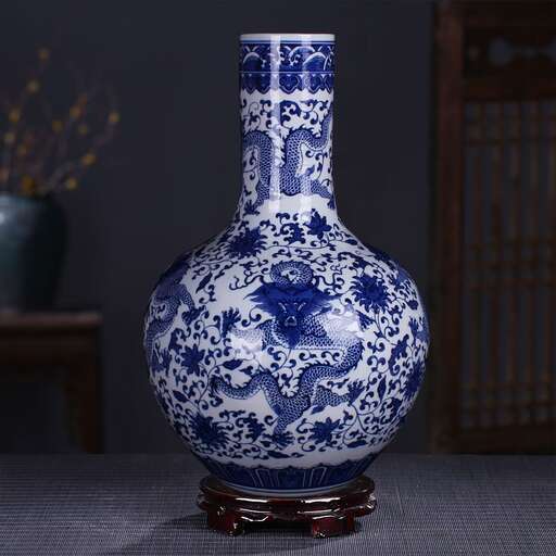 a blue and white vase sitting on a table.