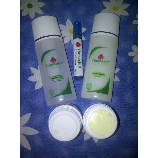 a set of cosmetic products on a blue blanket.