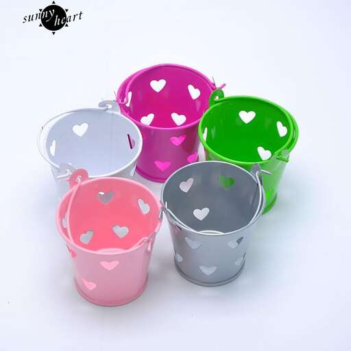 a set of three plastic cups with hearts painted on them.