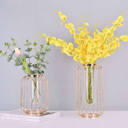 a couple of vases with yellow flowers in them.
