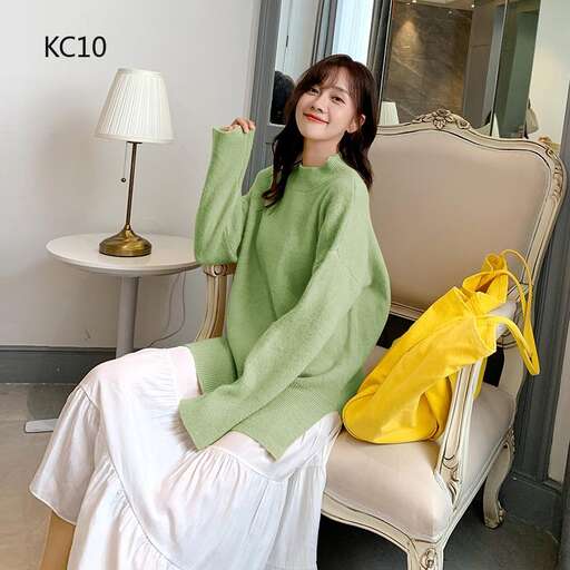 a woman sitting on a chair with a yellow bag.