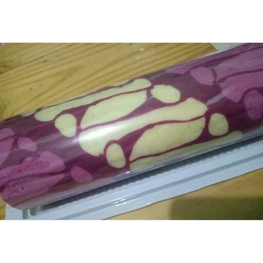 a box of purple and yellow roses.