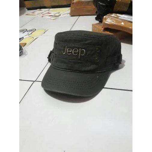 a black hat sitting on the ground next to a wooden table.