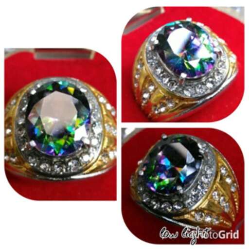 a ring with a green sapphire and diamond.