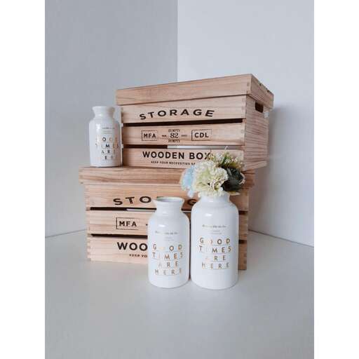 a set of three wooden boxes with white labels.