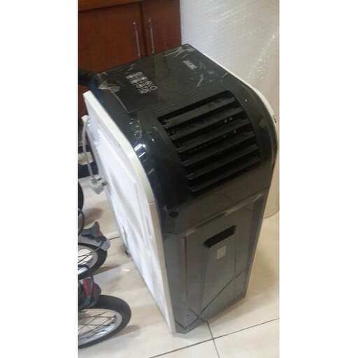 a large black appliance sitting on the floor.