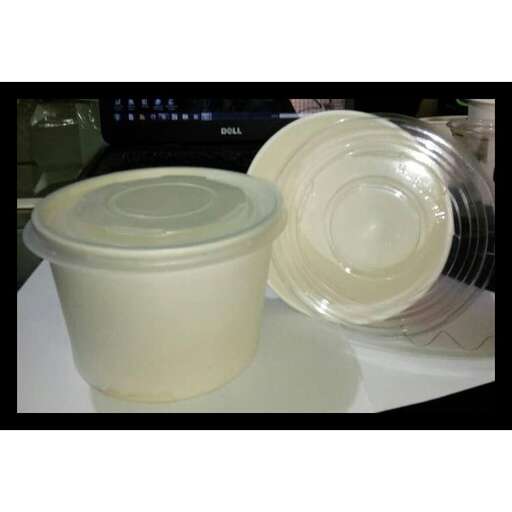a white bowl and two bowls are sitting on a table.