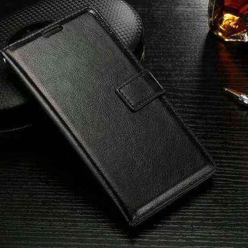 a wallet that is on a table with a glass.