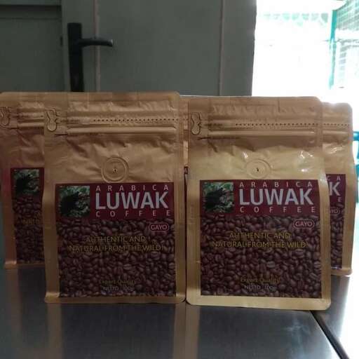 a bag of food on a table with a bag of coffee.