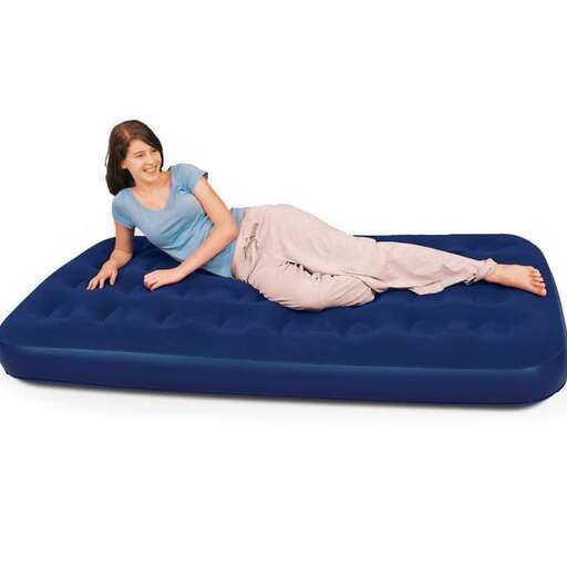 a woman laying on a blue mattress.