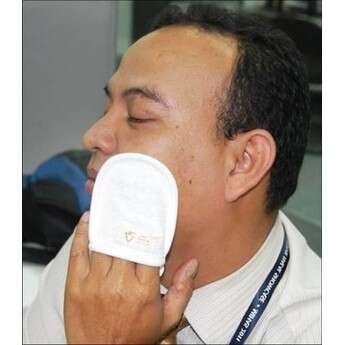 a man holding a towel over his nose.