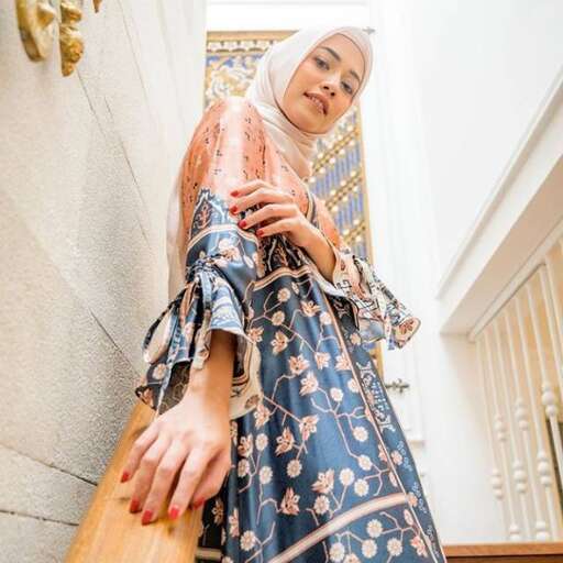 woman in traditional dress standing on the stairs