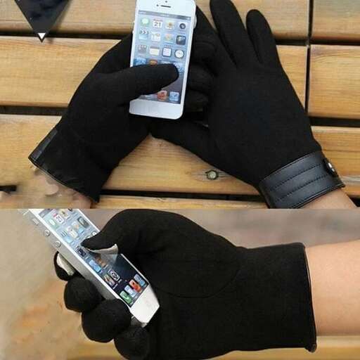 a person wearing black gloves holding a cell phone.