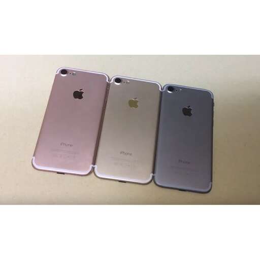 three iphones are shown with a pink case.