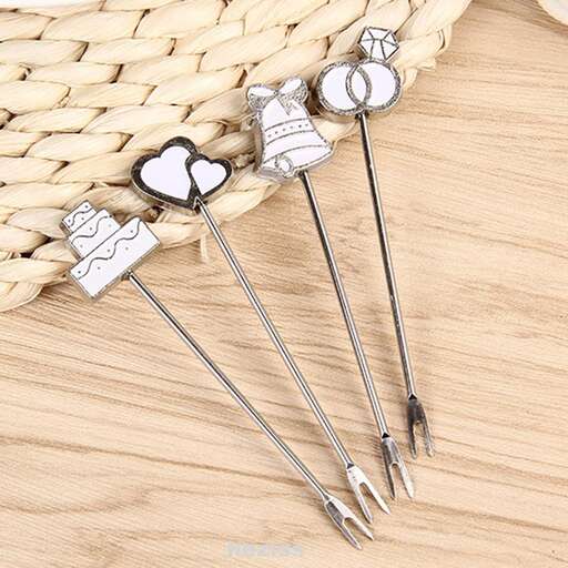 a set of three silver forks with hearts on top.