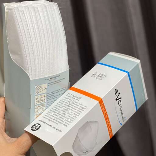 a person holding a box with a white paper inside.