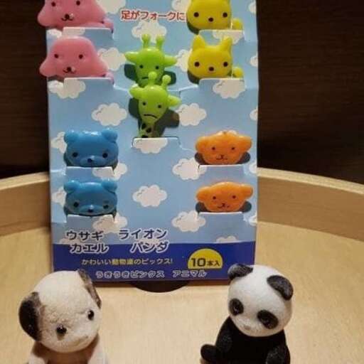 two stuffed panda bears sitting on a table.