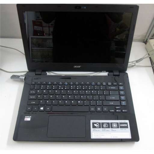 a black laptop computer sitting on top of a white desk.