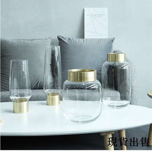 a table with a vase and some glasses on it.