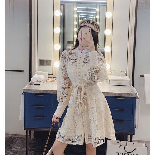 a mannequin wearing a white dress and hat with a cane.