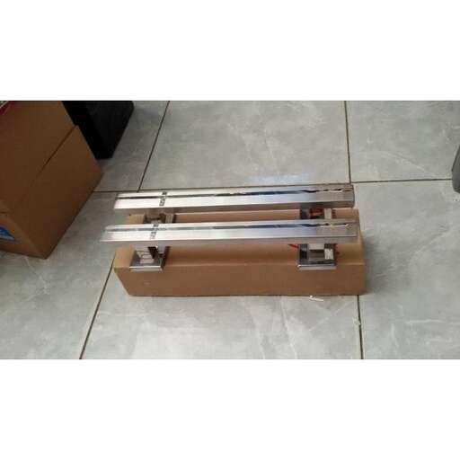 a cardboard box with a metal handle on it.