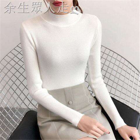 a model in a white turtleneck and skirt