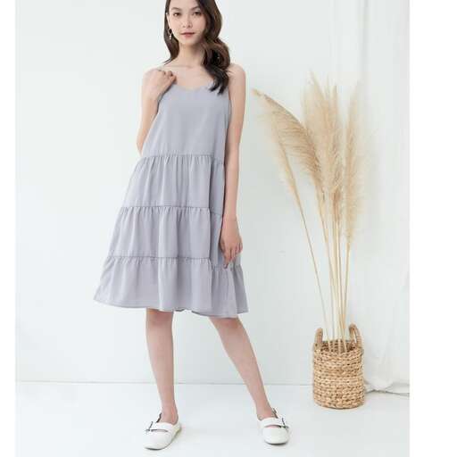 person in a light grey dress