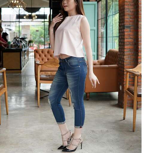 person in a white top and jeans