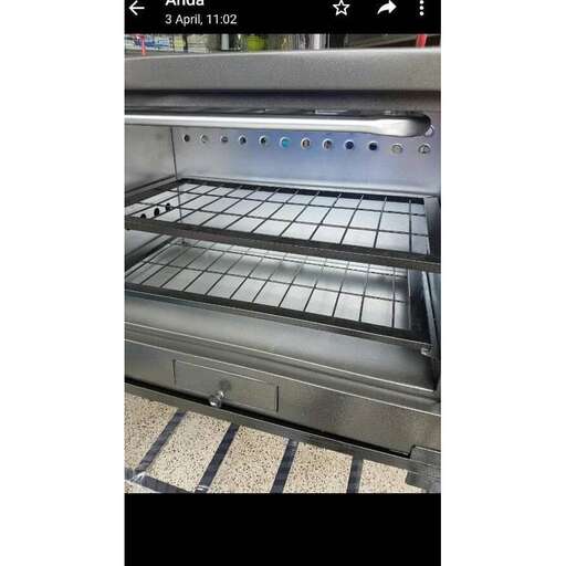 a stove with a glass door open with a digital screen.