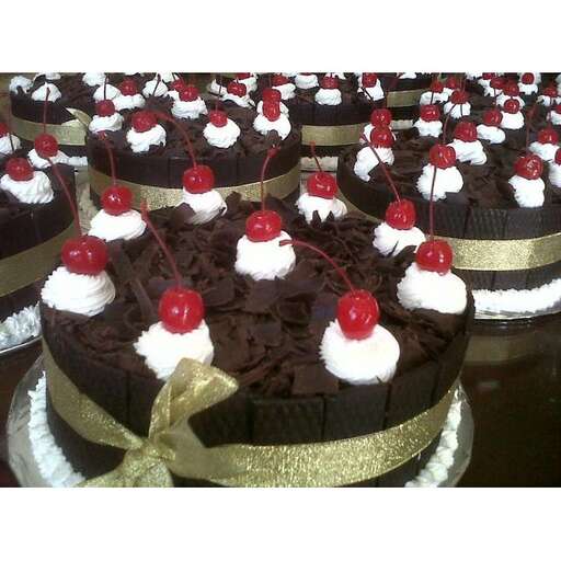 a chocolate cake with cherries and cherries on top.