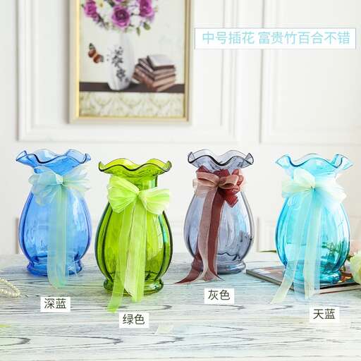 a table topped with three vases filled with flowers.