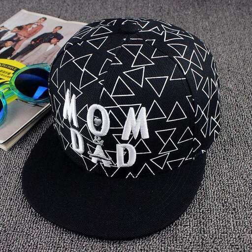 a hat with a baby on it and a pair of scissors.