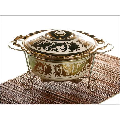 a small metal teapot with a lid.