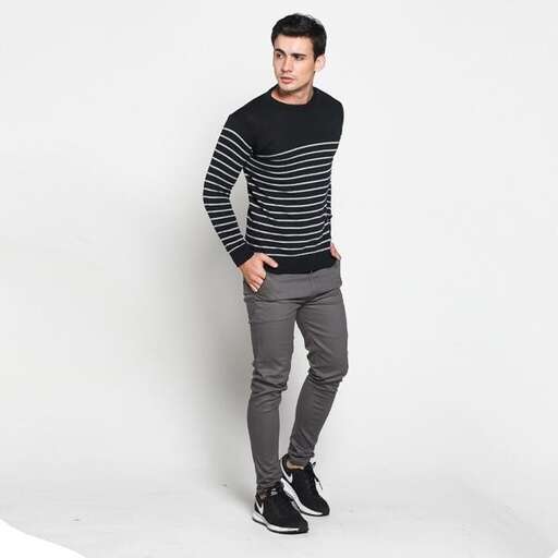 a model wears a striped sweater and a striped sweater.