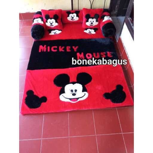 a bed with a panda and pandas bed spread.