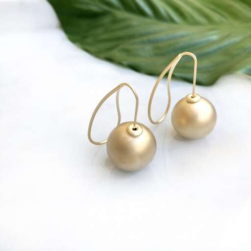 a pair of gold earrings.