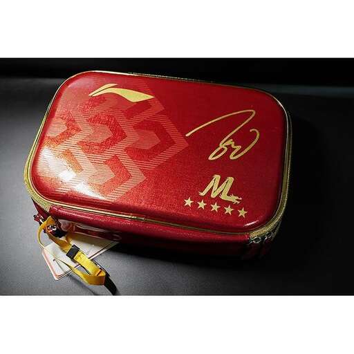 a red and gold case with a gold logo on it.