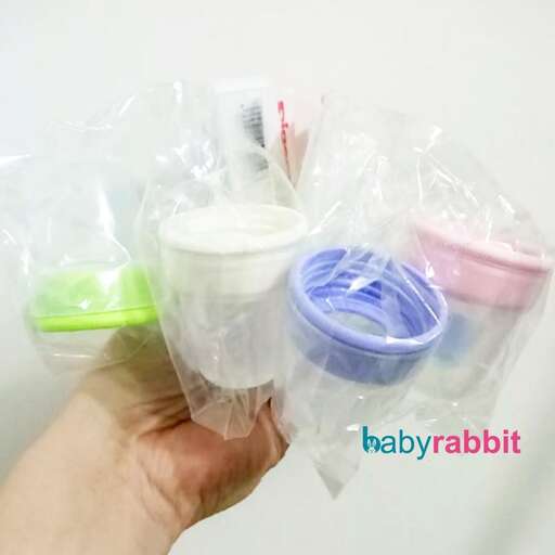 a person holding a plastic bag filled with toothbrushes.
