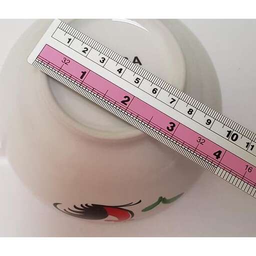 a measuring cup with a temperature gauge on top of it.
