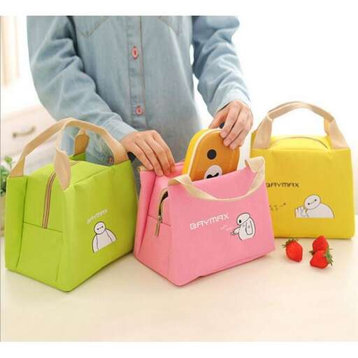 a girl holding a colorful bag with a dog on it.