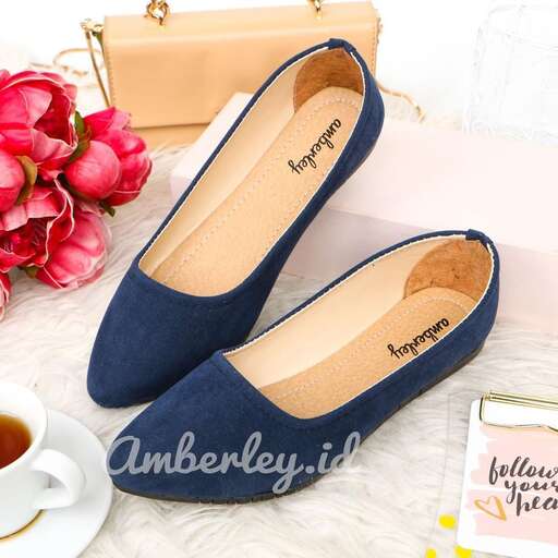 a pair of blue flat shoes with a gold clutch and a pink bouquet of roses.