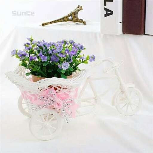 a flower arrangement in a flower pot on a table.