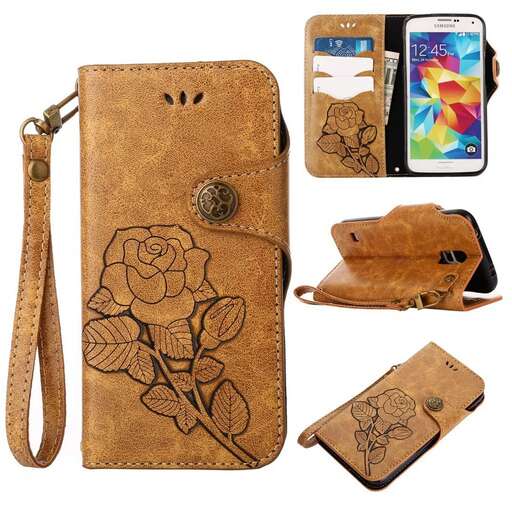 a leather wallet with a flower design on it.