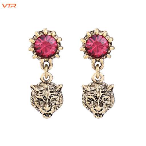 a pair of earrings with a pink sapphire and diamond.