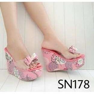 a pair of shoes with floral print on the bottom.