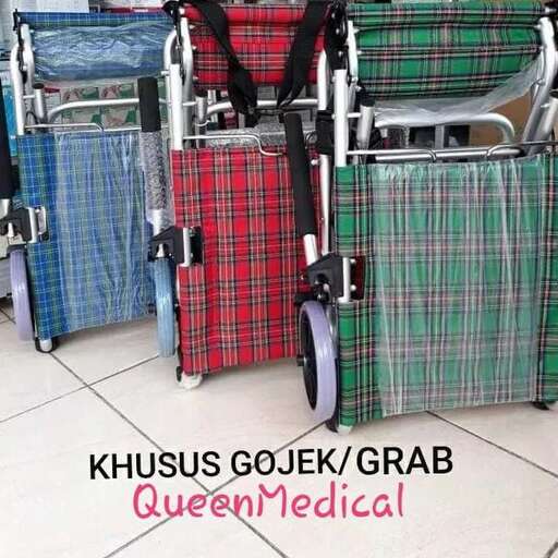 a wheelchair with a plaid suitcase and a green and black bag.