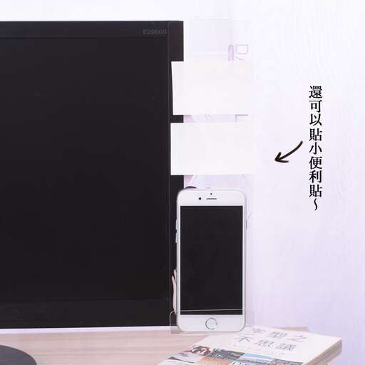 a phone is sitting on a desk next to a television.