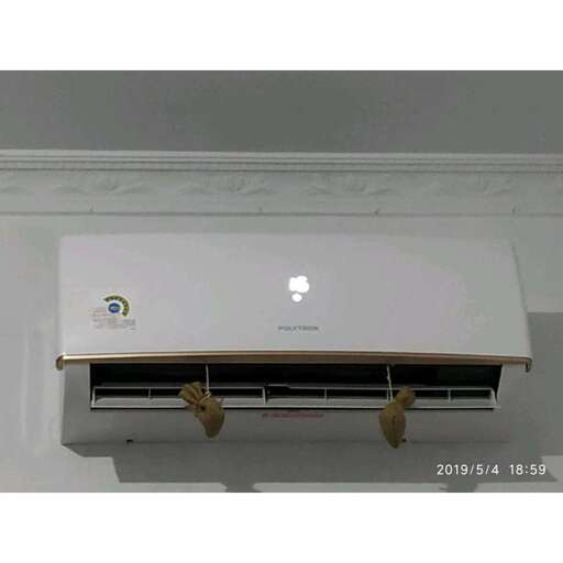 a white laptop computer sitting on top of a shelf.