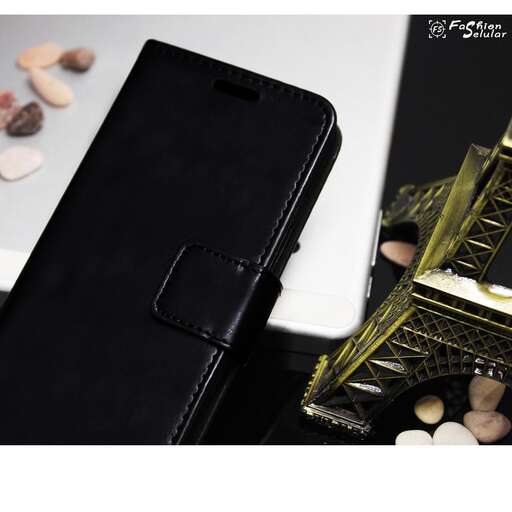 a cell phone sitting next to a black case.