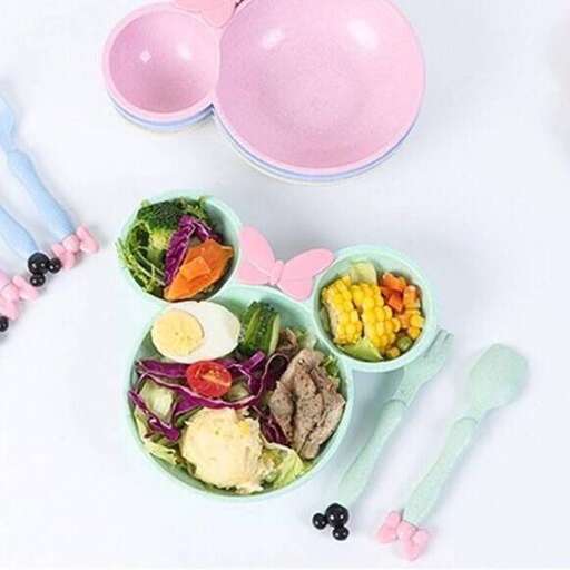 a table topped with bowls of food and utensils.